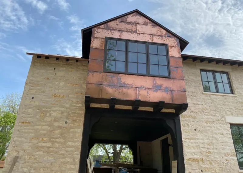 Copper metal panel facade on a stone building for Roof Repair in Canyon Lake